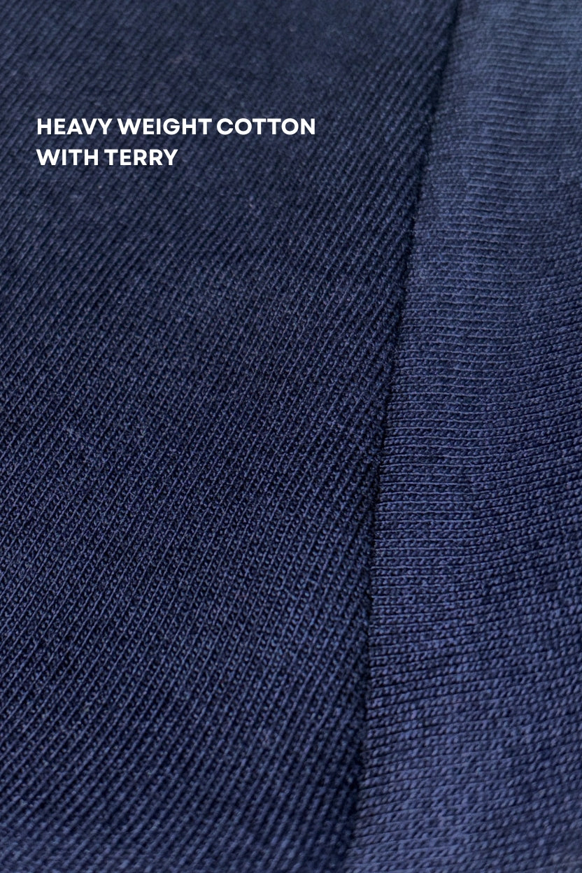 Close-up of shreads blue fabric of relaxed fit navy blue tshirt with 'Heavy Weight Cotton with Terry' text