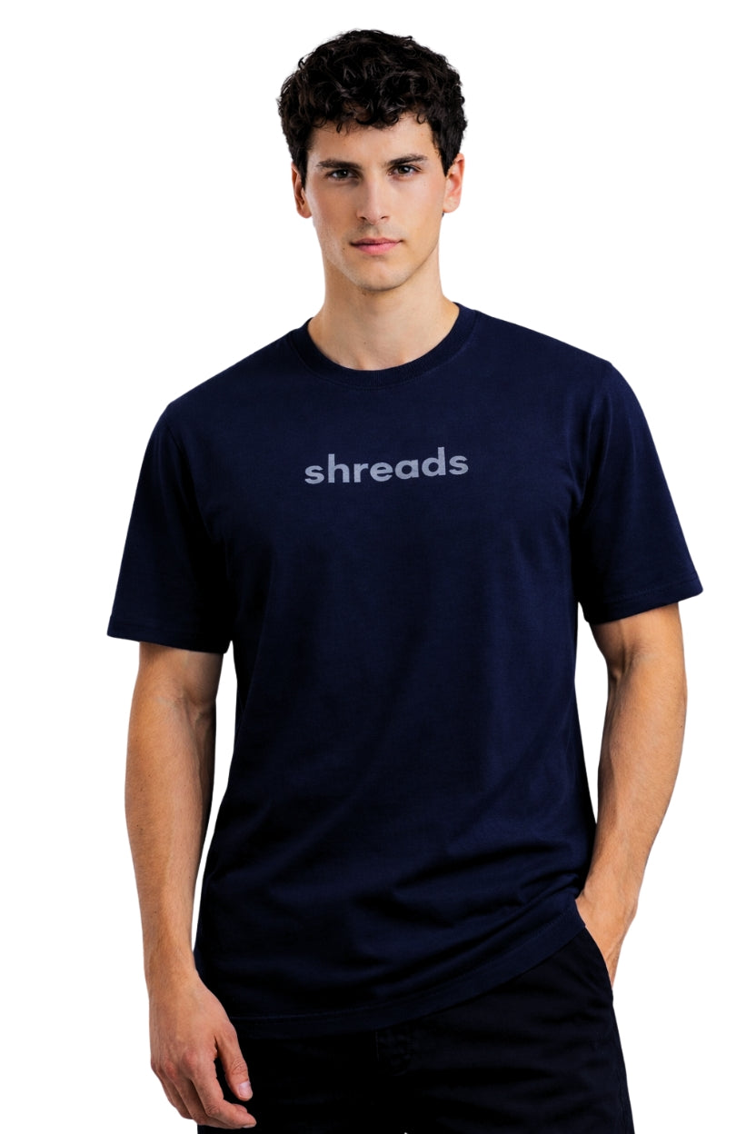 Man wearing a relaxed fit navy blue t-shirt in midnight shade with 'shreads' logo on a white background
This is a tshirt in relaxed fit made of premium cotton 100% with terry texture, made by shreads, shreadslife, shred, shread, shredlife